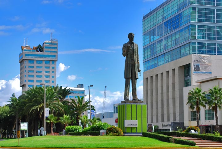 A man statue near a clinic building.