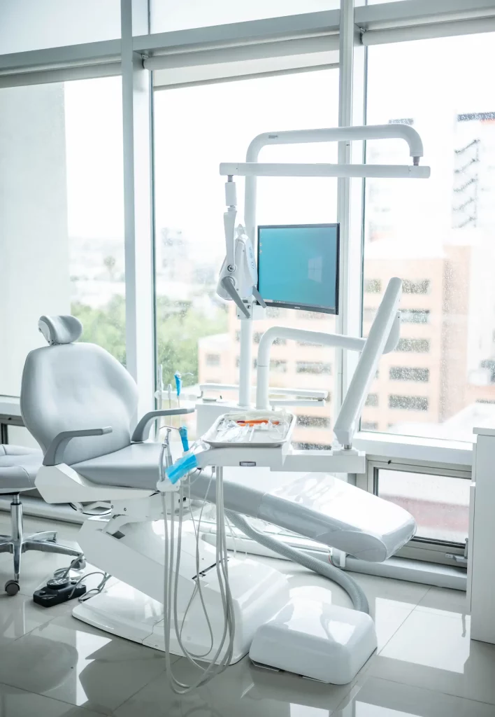 A dental chair and monitor in a dentist's office enhance The Experience.