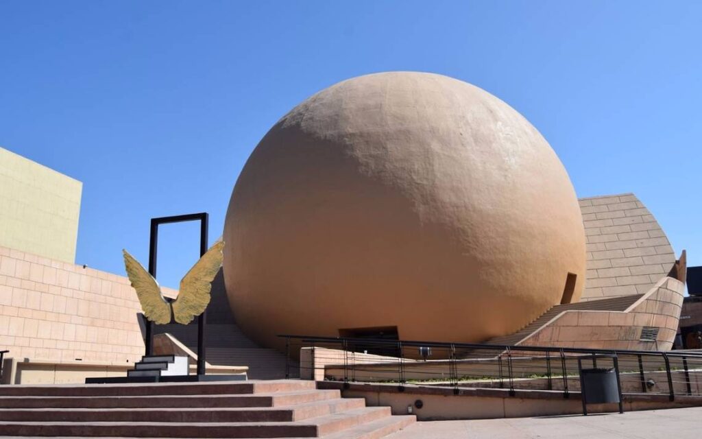 A gigantic egg-shaped landmark sits attractively in front of a grand building, offering three cool reasons for visiting Tijuana.