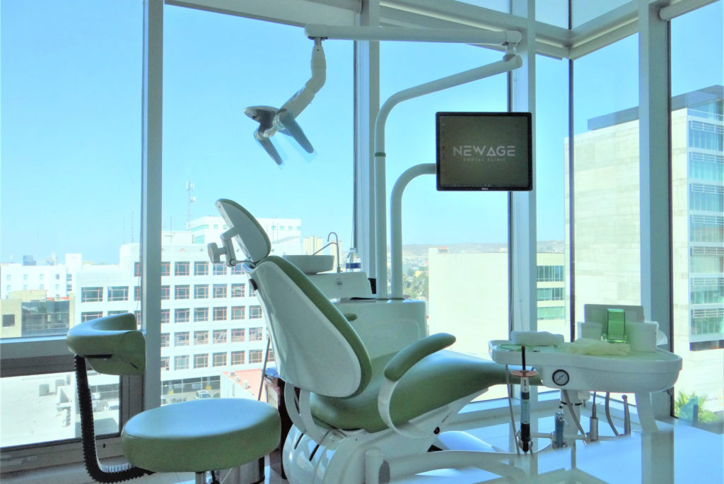 A dental chair in a room with a view of the city, perfect for Tijuana dental work.