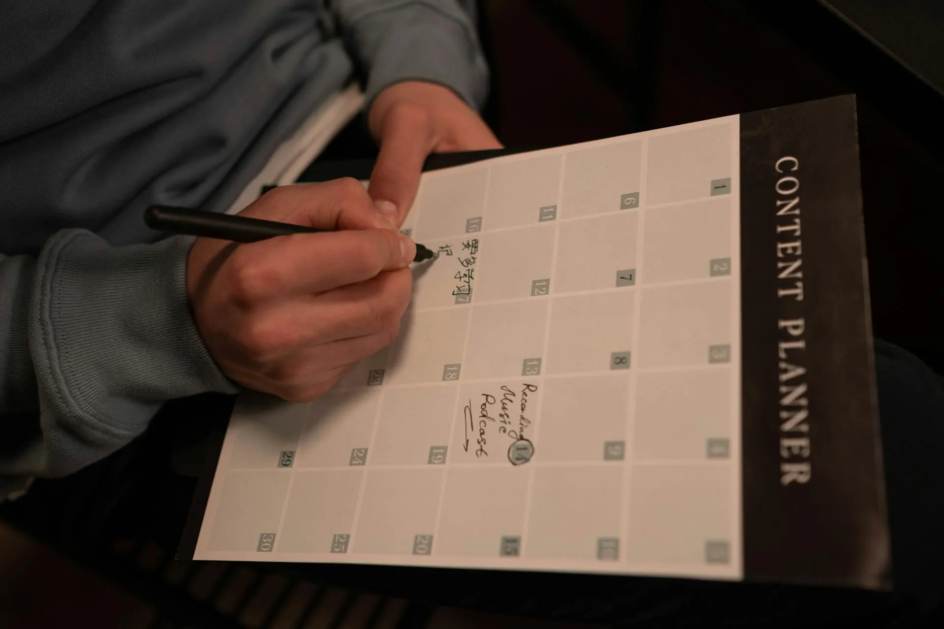 A person writing in a content planner with a pen, focusing on a schedule grid for healing time after a tooth extraction.