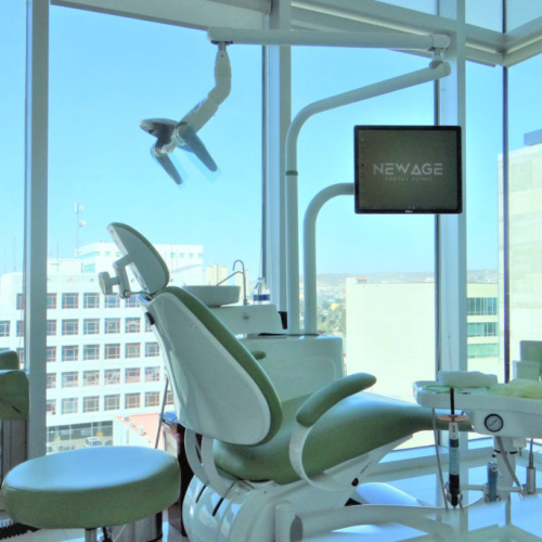 A dental chair in a room with a view of the city, perfect for Tijuana dental work.